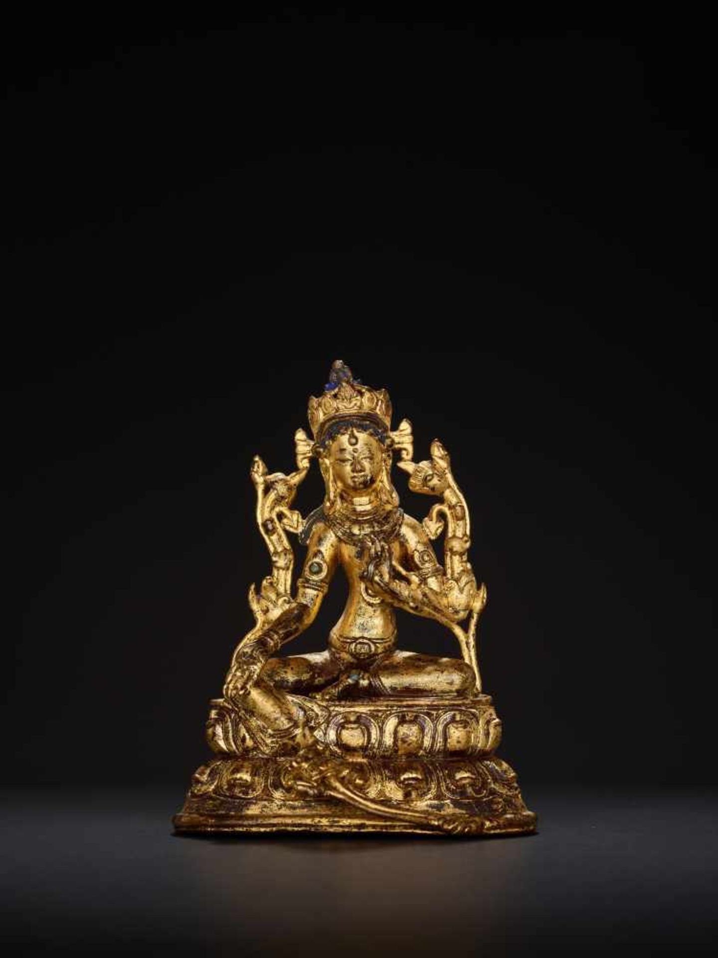 A TURQUOISE INLAID GILT BRONZE FIGURE OF A GREEN TARA, TIBET, 17th – 18th CENTURYCast and chased