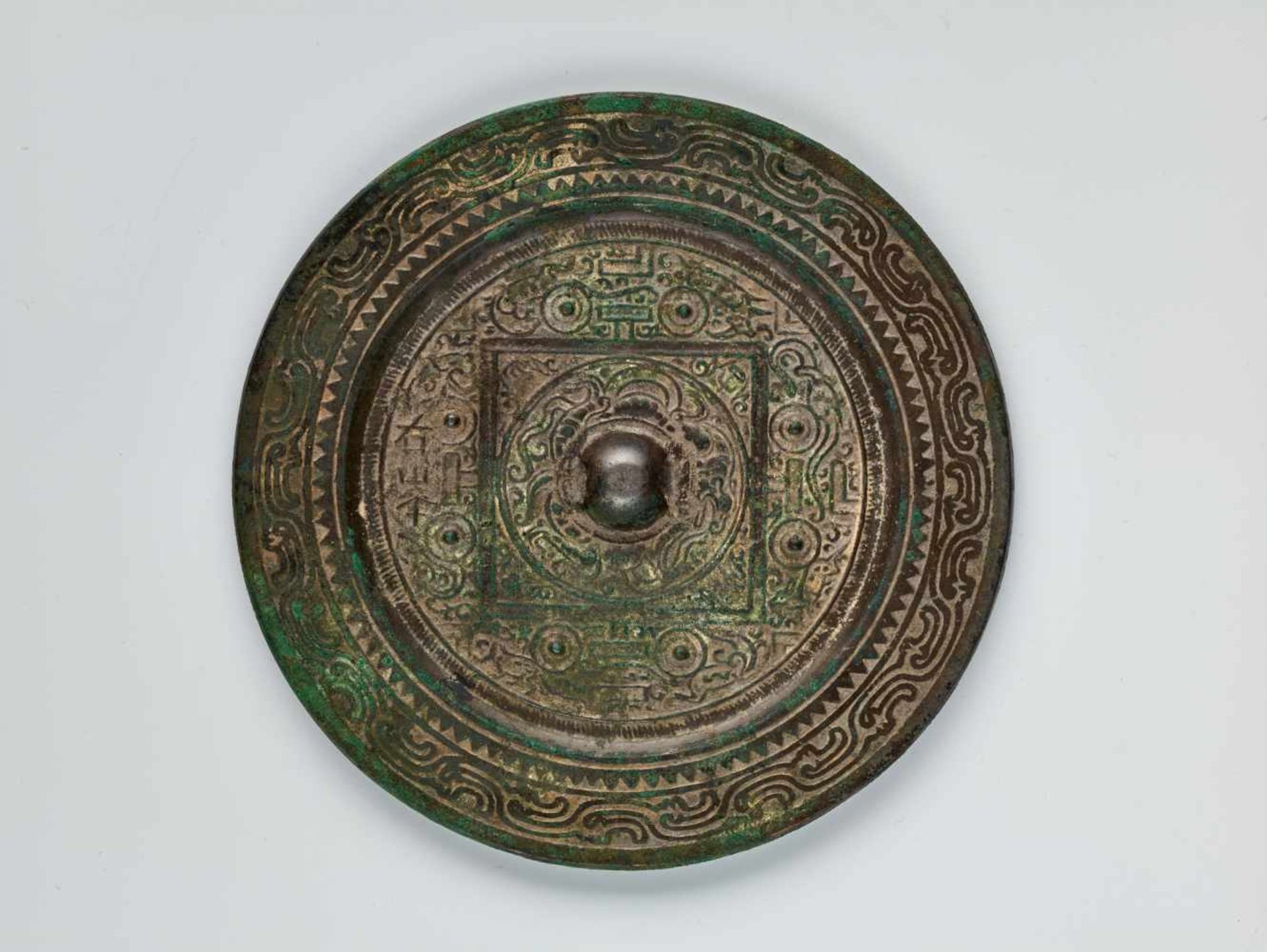 A LARGE INSCRIBED 'TLV' BRONZE MIRROR, HAN DYNASTYCast bronze with high relief, the patina with