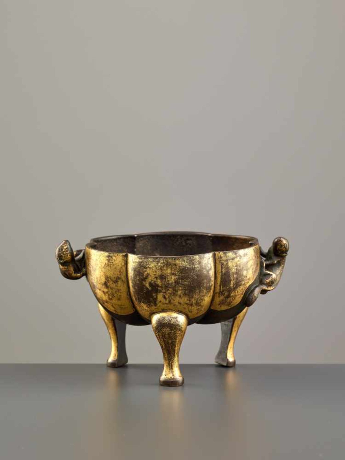 A PARCEL GILT TRIPOD CENSER WITH MONGOOSES, MING DYNASTY Parcel gilt copper bronze alloy, cast and