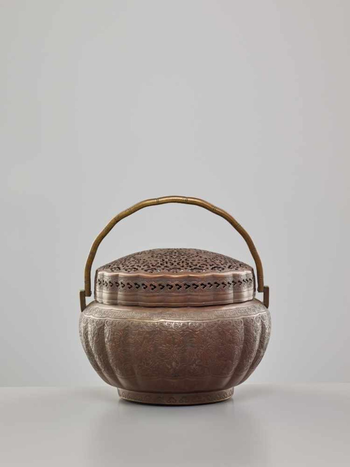 A COPPER HAND-WARMER WITH RETICULATED COVER, QING DYNASTYThe metal with an even reddish-brown