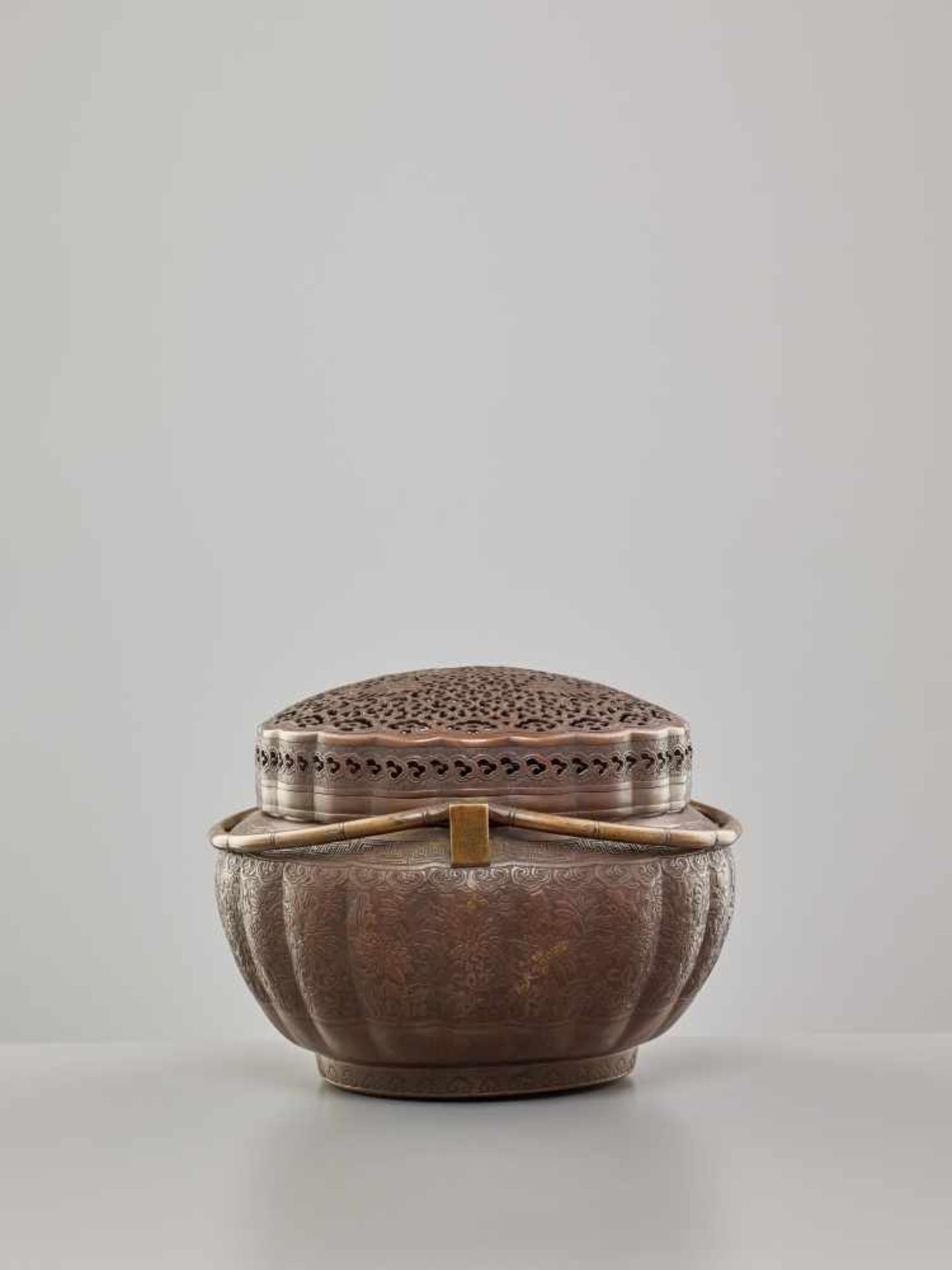 A COPPER HAND-WARMER WITH RETICULATED COVER, QING DYNASTYThe metal with an even reddish-brown - Image 2 of 15