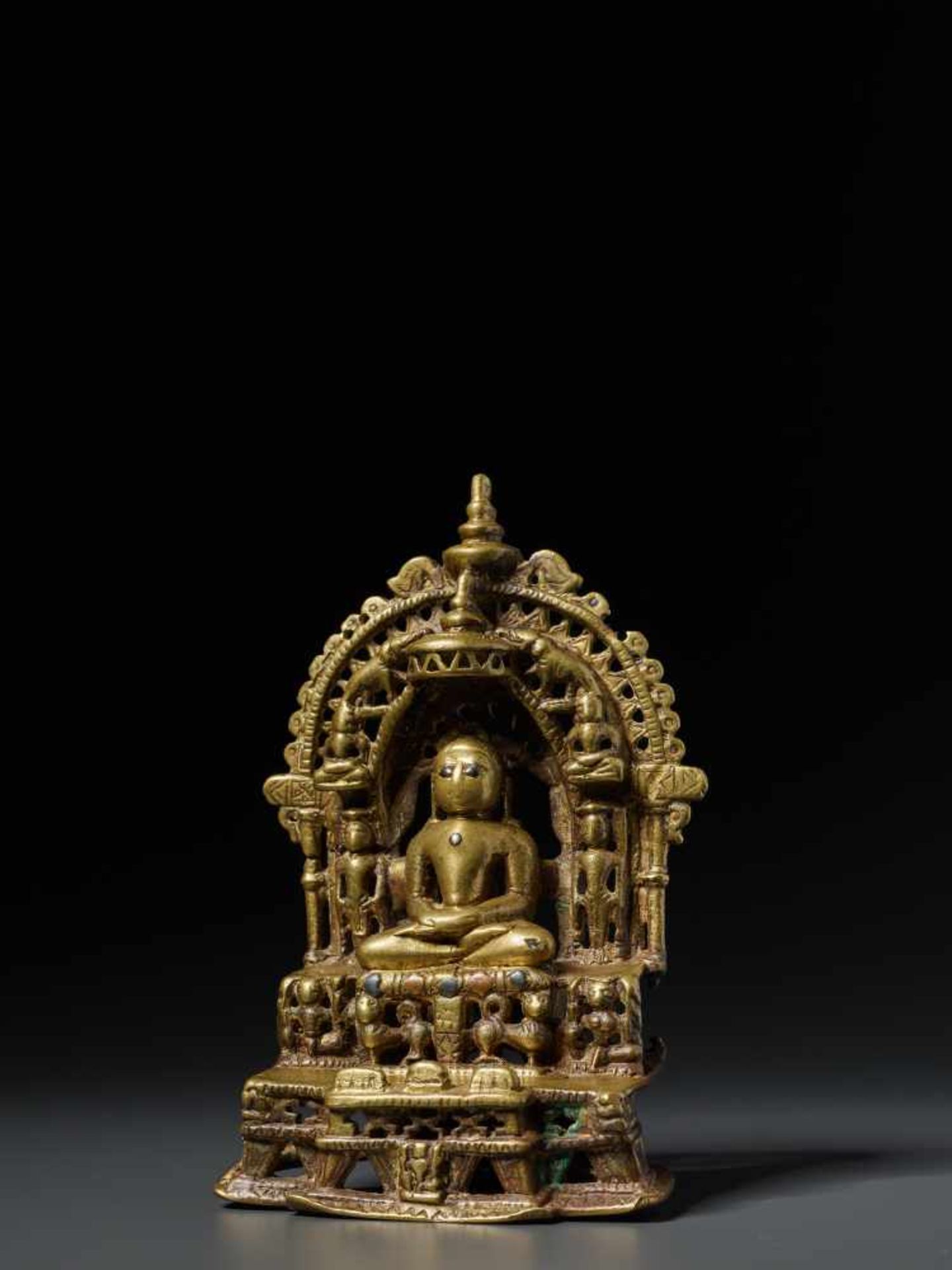 A SILVER AND COPPER INLAID JAIN BRASS SHRINE WITH MAHAVIRA, 15th – 16th CENTURY Brass with copper