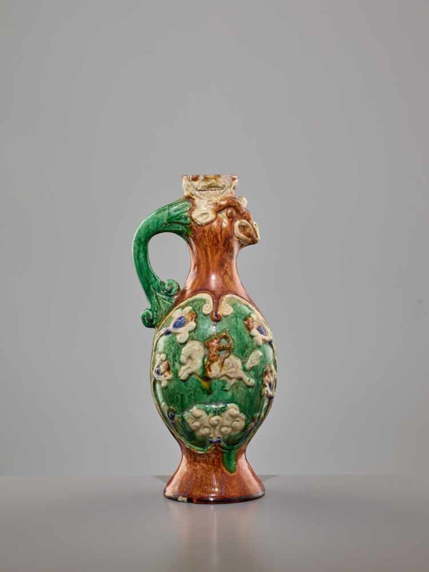 A RARE SANCAI-GLAZED 'PHOENIX' EWER, SONG DYNASTY The finely potted body of elegant ovoid form,