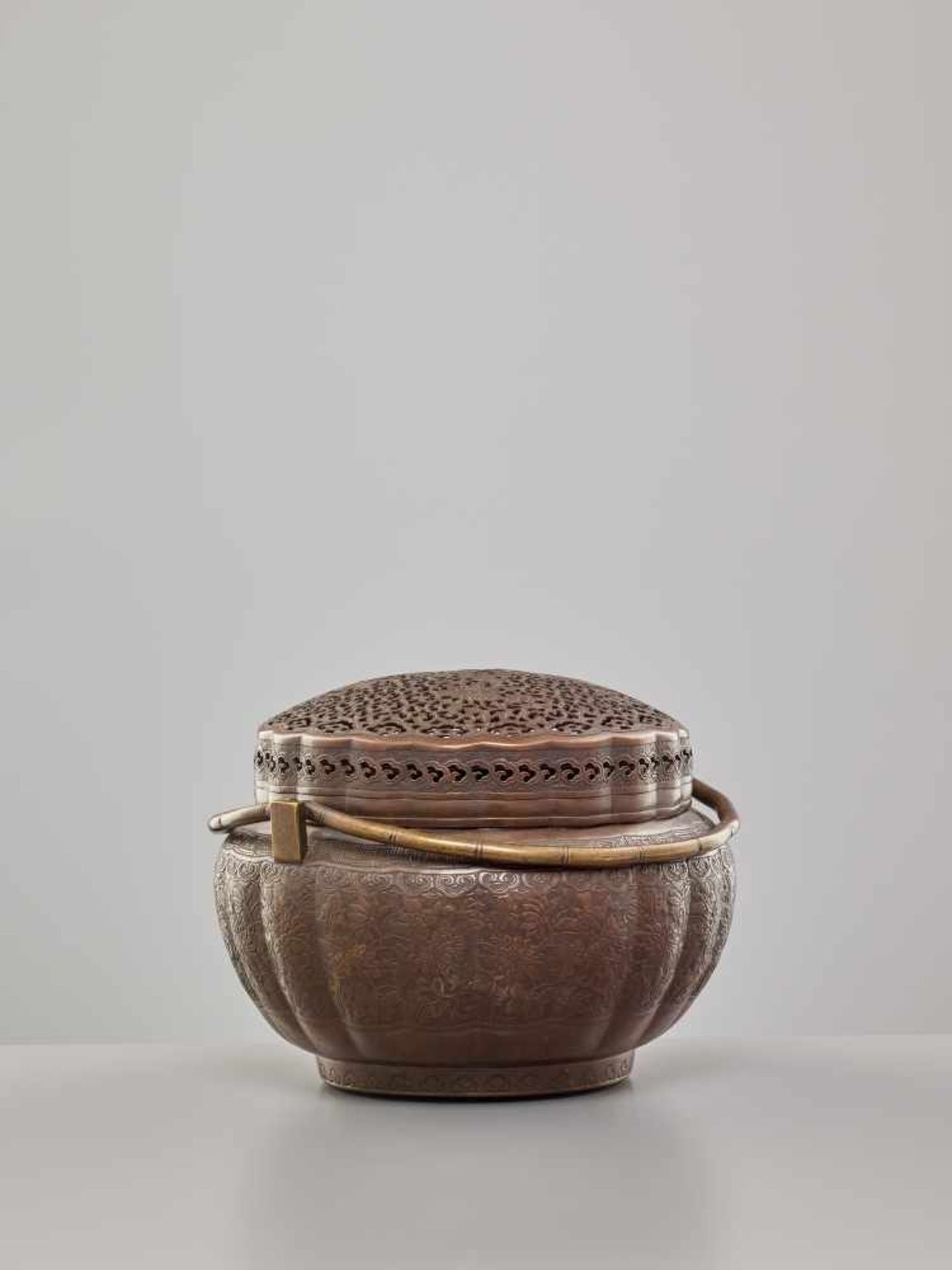 A COPPER HAND-WARMER WITH RETICULATED COVER, QING DYNASTYThe metal with an even reddish-brown - Image 3 of 15