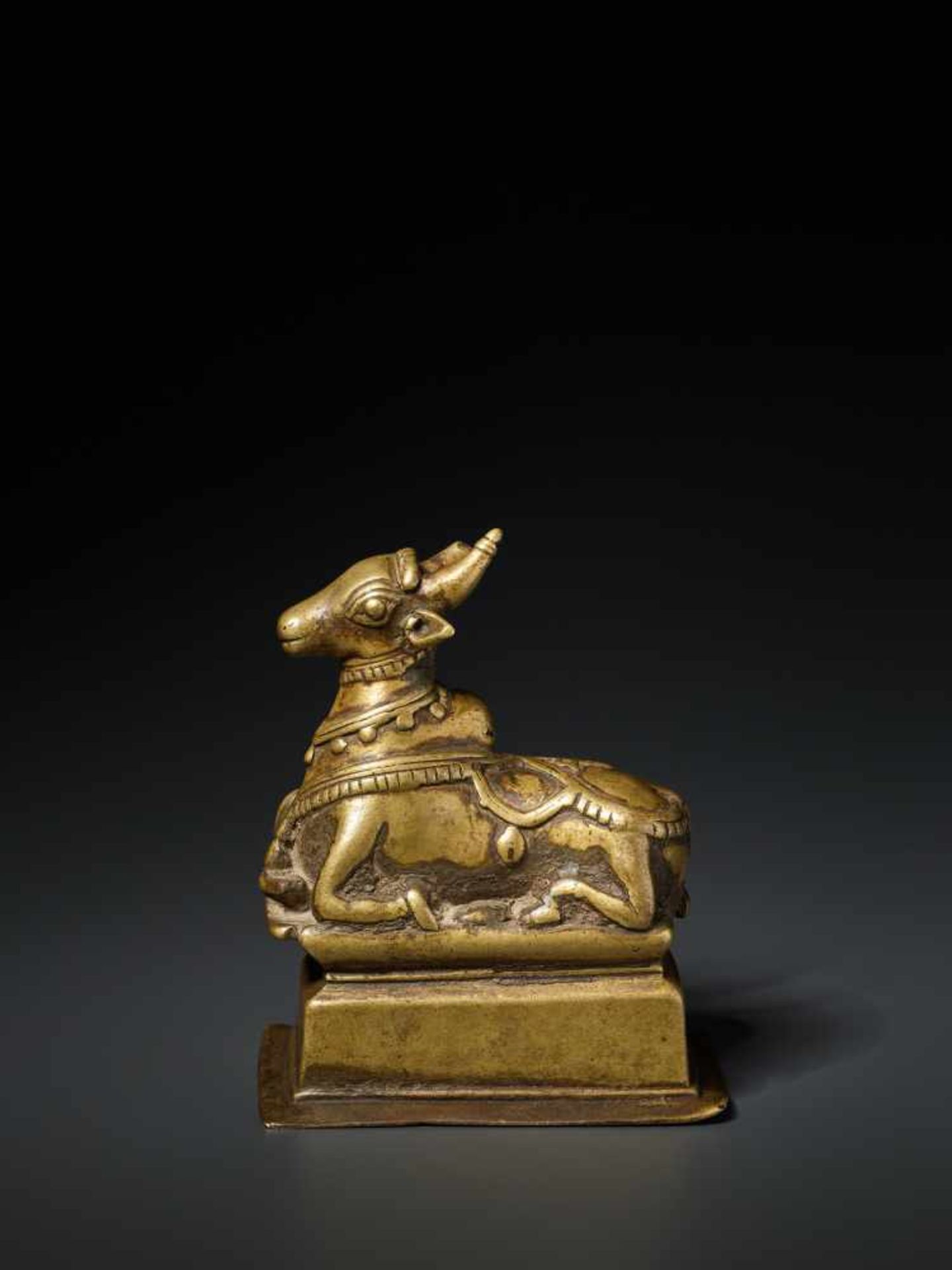 AN INDIAN BRASS FIGURE OF NANDI, 15th CENTURY Brass India, Himachal Pradesh, 15th century Nandi is