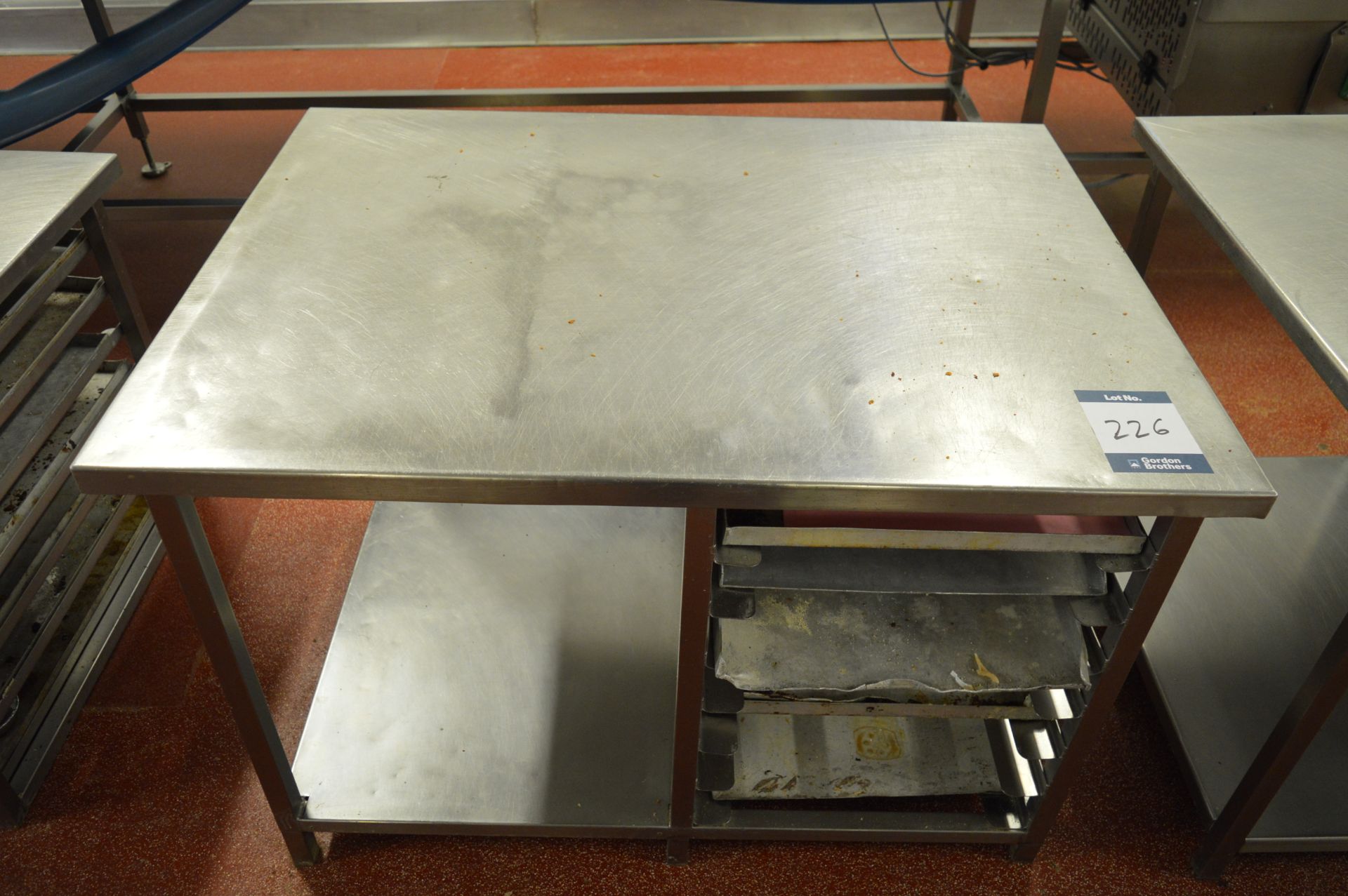Stainless steel work bench with tray storage, 1.15m (w) x 0.86m (d) x 0.74m (h) (Located at Crantock
