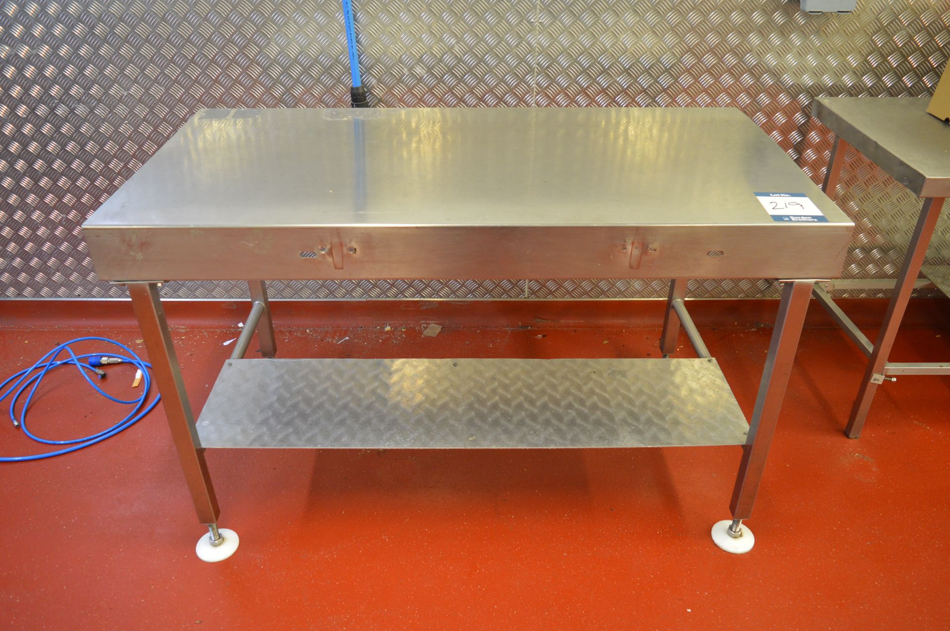 Stainless steel adjustable height work bench, 1.4m (w) x 0.72m (d) (Located at Crantock Bakery,