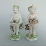 A pair of Derby Porcelain Cherubs holding baskets of flowers Circa 1765 patch marks Size - 11 cm