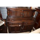 An Ercol oak dresser, doors to upper section,