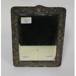 A silver framed mirror with an easel back, blank cartouche,