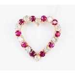 An yellow metal (18ct gold tested) diamond and ruby brooch, in the form of an open heart shape,