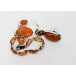 A large amber and silver ring, similar pendant,