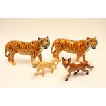 Four Beswick animals, comprising two tigers, fox and lion cub,