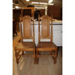 A set of four oak hall chairs, in the Carolean style,