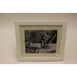 A signed, framed and glazed photograph of Norman Wisdom,