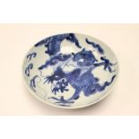 An 18th Century Chinese dish, painted in underglaze blue with a dragon chasing a pearl,