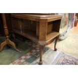 An early 20th Century mahogany open bookcase table, the top applied with mahogany quarter veneering,