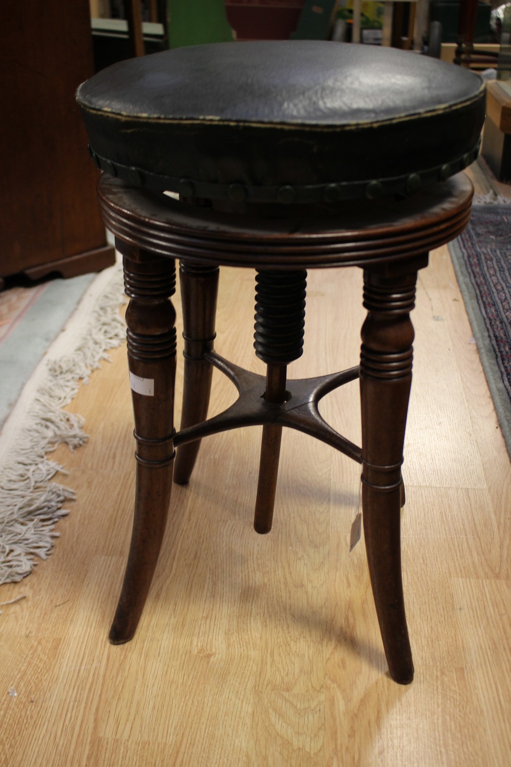 A George III revolving piano stool