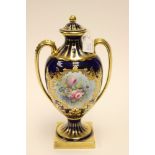 Stefan Nowacki for Lynton porcelain, a twin handled urn vase, painted with floral bouquet,