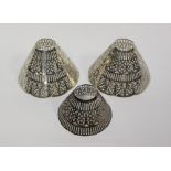 A set of three white metal pierced lamp shades of various sizes, total weight 229 grams/7.