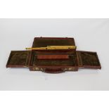 A folding wooden and brass ruler in leather case,