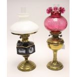 Two oil lamps, brass based ceramic oil reserve,