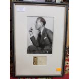 A framed photograph of Noel Coward,