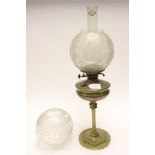 A heavy brass based oil lamp, etched glass globes, funnel,