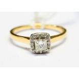 A princess cut diamond ring, with a halo surround of small diamonds,