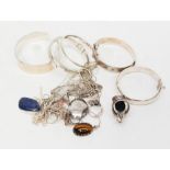 A quantity of silver bangles, necklaces and polished gemstone pendants,