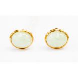 A pair of Jade type earrings, with oval rub-over stones set in 9ct gold mounts stamped .