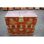 A Korean camphor wood brass mounted chest, the hinged lid opening to reveal a storage section,