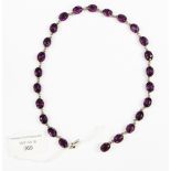 A boxed, circa 1930's purple glass stone, covered back rub over set necklace,