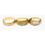 A group of three 14ct gold rings with various designs,