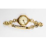 A ladies 9ct gold watch on plated bracelet