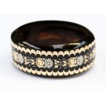 A Victorian tortoiseshell bangle with floral Picque work, gold and silver inlays,