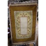 A Turkish golden brown and cream ground rug with geometric decoration,