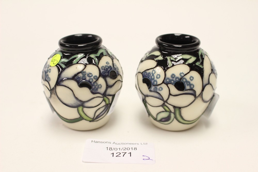 A pair of Moorcroft Trial miniature vases, both 1st quality, white flowers on black ground,