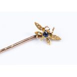 A rose and yellow metal stick pin, the finial designed as a fly, set with a sapphire and diamonds,