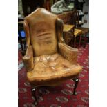 ****Ex Luddington Manor****A Gentlemans wing back leather upholstered armchair,