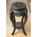 A 20th Century Oriental ebonised jardiniere stand with undertier,