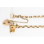 A double link chain in 9ct gold with a padlock and a Church charm, total gross weight 18.