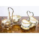 A silver plated milk and sugar set together with another,