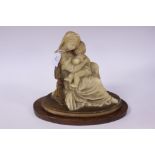 An Italian wax sculpture of the Madonna and Child, raised on a wooden plinth,