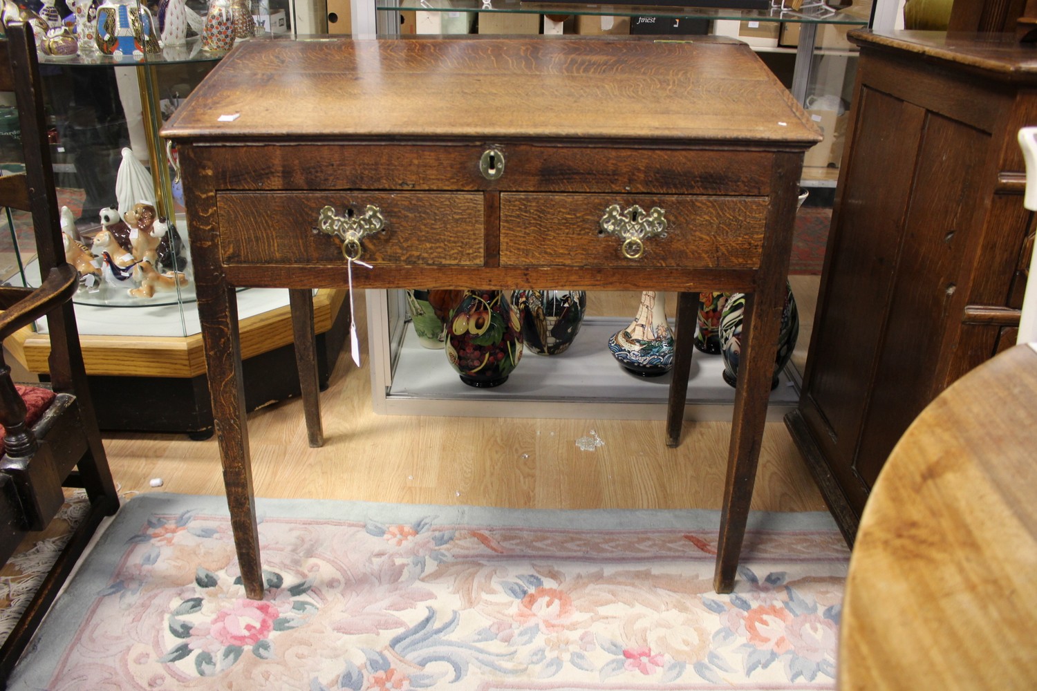 ****Ex Luddington Manor****An 18th Century joined oak slop top desk, fitted with two drawers,