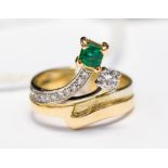 An emerald and diamond dress ring set in 18ct yellow and white gold,