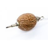 A novelty nutmeg propelling pencil, with white metal fixings,