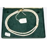 A double string of Chinese cultured button pearls,