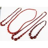 Four cherry amber type necklaces, with varying sizes of oval and round graduated beads,