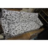 ****Ex Luddington Manor****A contemporary black and white floral upholstered three seater settee,